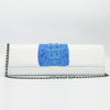 Blue and white Kate crocodile and leather clutch. Handcrafted from Italian saffino leather. Sustainably sourced crocodile ascent, magnetic closure, interior pocket, and removable shoulder strap with a 22” drop. 