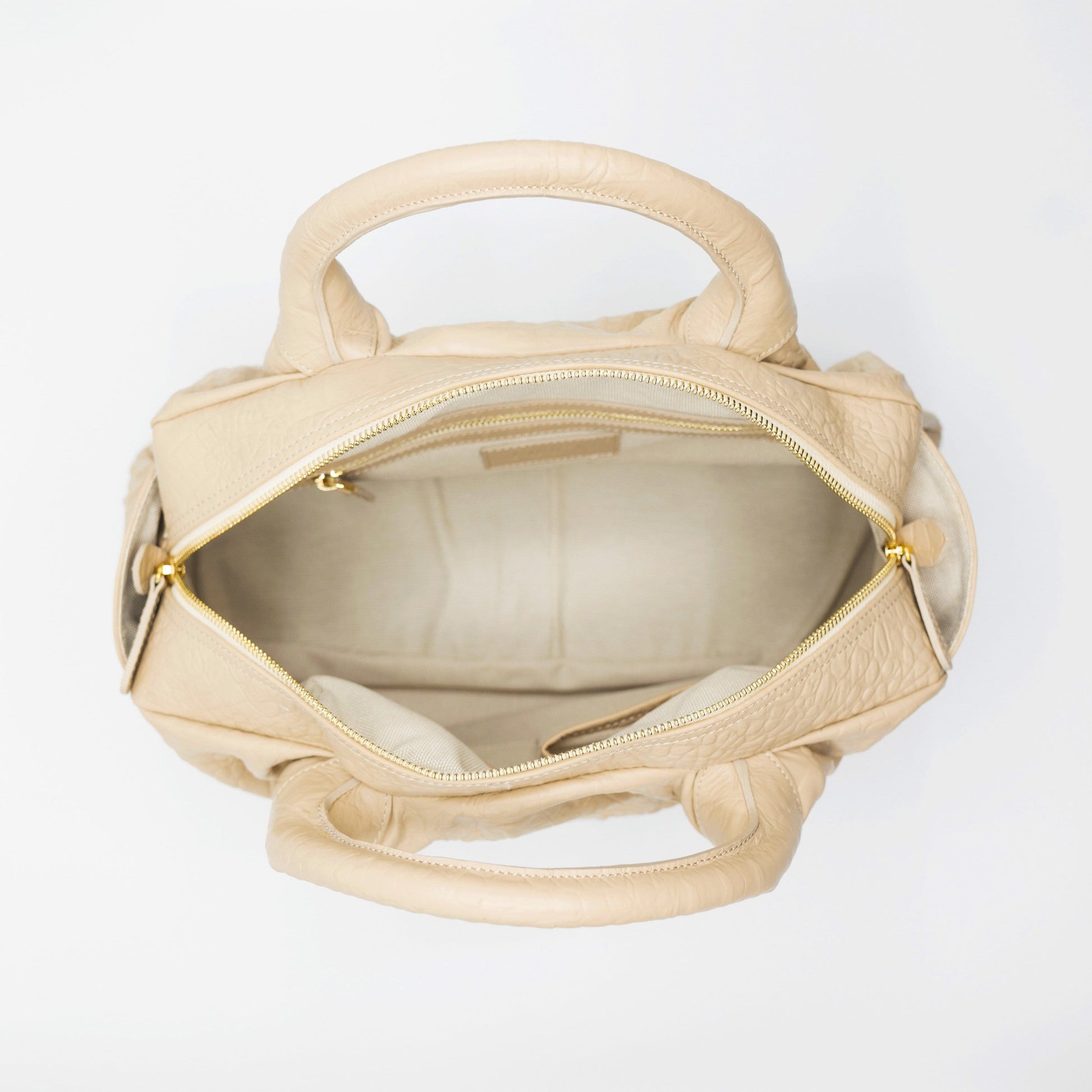 Blush sustainably sourced, crocodile embossed Turkish leather. This medium-sized handbag, tote, and messenger is expertly crafted to our exacting standards. 