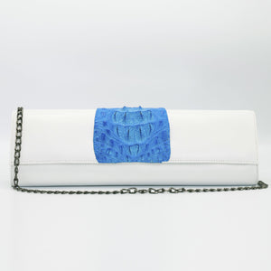 Blue and white Kate crocodile and leather clutch. Handcrafted from Italian saffino leather. Sustainably sourced crocodile ascent, magnetic closure, interior pocket, and removable shoulder strap with a 22” drop. 
